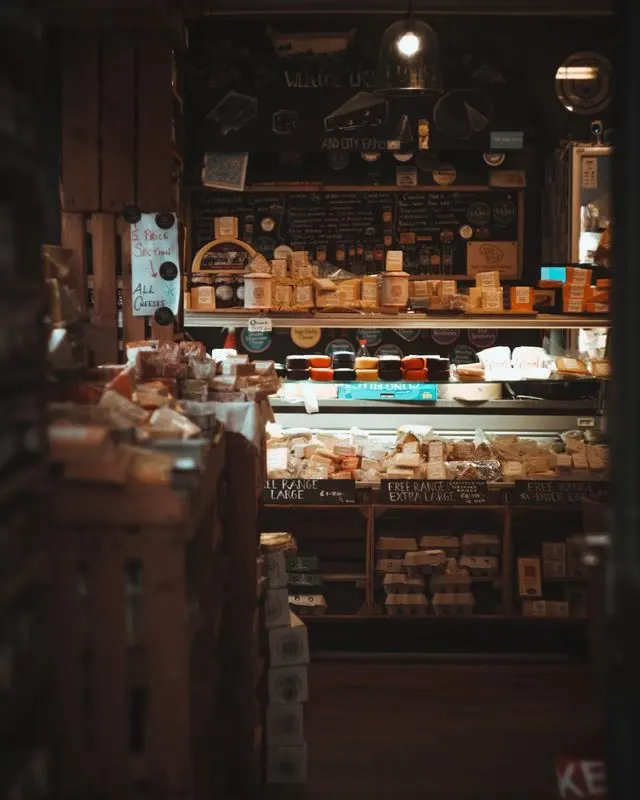 Intérieur d’une épicerie fine avec étal de fromages et produits artisanaux